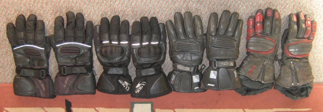 4 pairs of motorcycle gloves in a liine